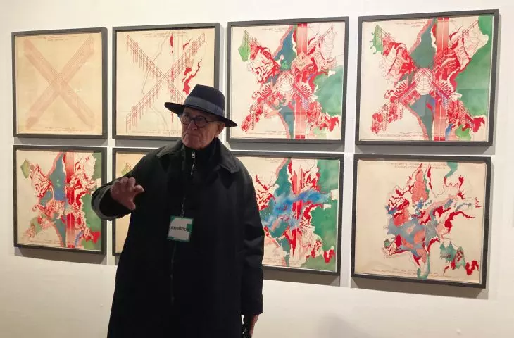 Peter Cook in the background of an exhibition of drawings - Ideas of Cities