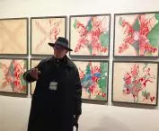 Peter Cook in the background of an exhibition of drawings - Ideas of Cities