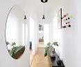 The hallway is decorated with a colorful Hang it all hanger designed by Charles and Ray Eames