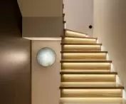 The staircase is illuminated by colored lamps
