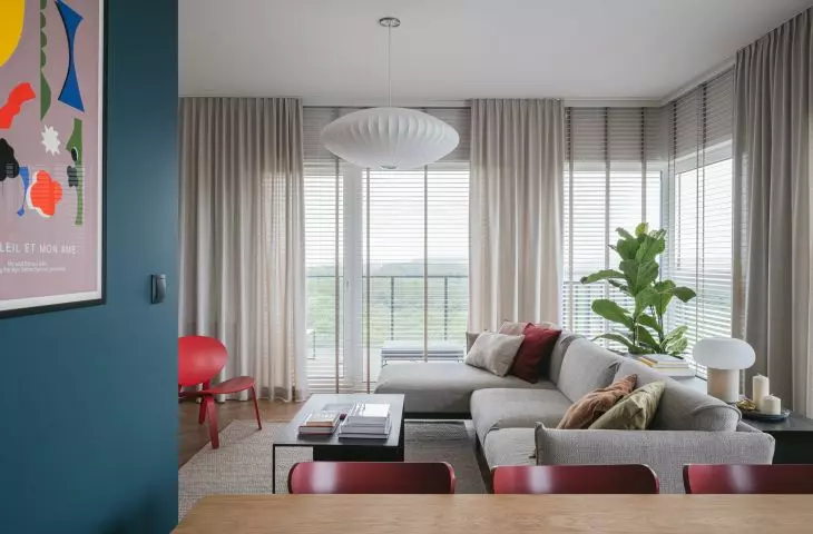 The wall in the living area is almost entirely covered by windows