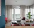 The wall in the living area is almost entirely covered by windows