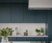 The kitchen cabinets are kept in a blue sea color