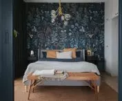 The main accent in the bedroom is the patterned wallpaper