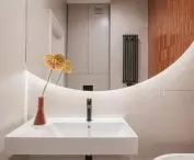 Round mirrors are illuminated from underneath