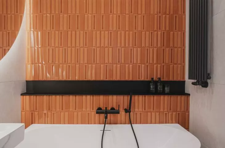 The main accent in the bathroom is formed by brick tiles
