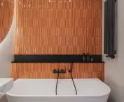The main accent in the bathroom is formed by brick tiles