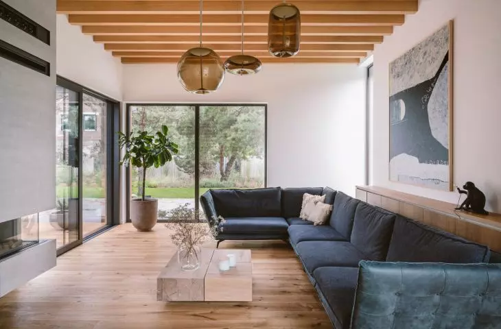 The living room is dominated by a navy blue sofa and glass lamps
