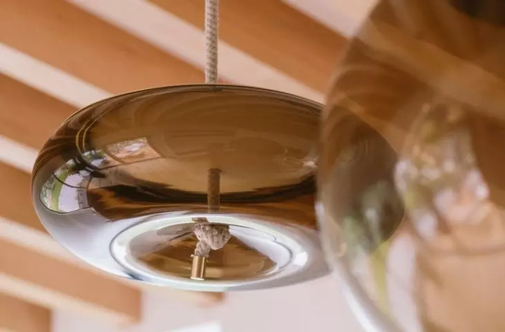 Strings of lamps in the living room resemble candle wicks