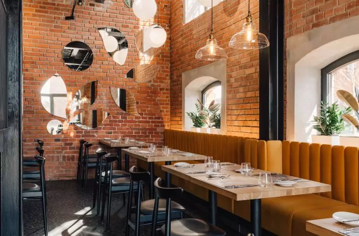 The industrial character of the interior is built primarily by preserving the brick and the original size of the windows