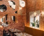 The industrial character of the interior is built primarily by preserving the brick and the original size of the windows