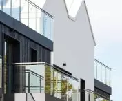 Trees are reflected in the panes of the balconies