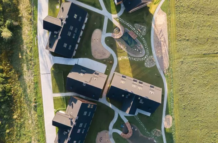 The first stage contains eight buildings connected by organic pathways
