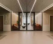 The corridor, and behind the glass door, the living room