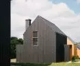 Prosta forma z dwuspadowym dachem nawiązuje do budynków na Kaszubach